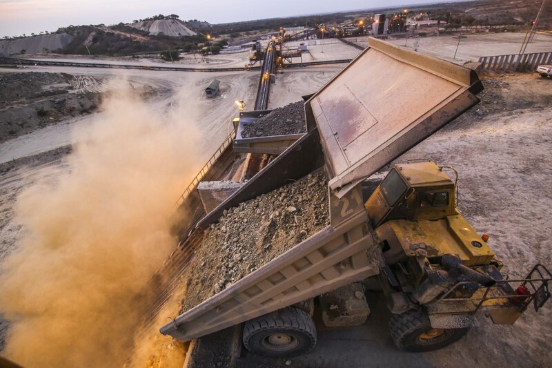 Dump trucks indicating different types of ore needed for correct blending in the processing cycle at Williamson 1